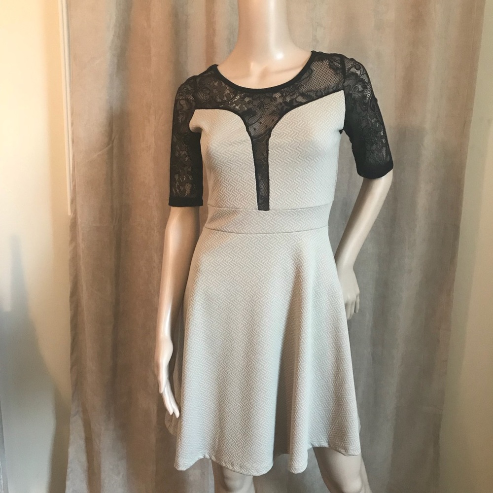 NWOT beige and black dress with lace accents.